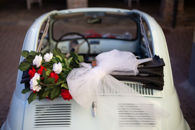 overhead-shot-bouquet-flowers-placed-top-car-with-blurred-background_181624-9427